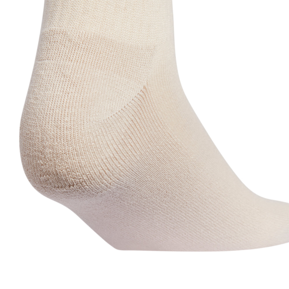A pair of top rated womens high quarter socks displayed on a running track, emphasizing their athletic design.