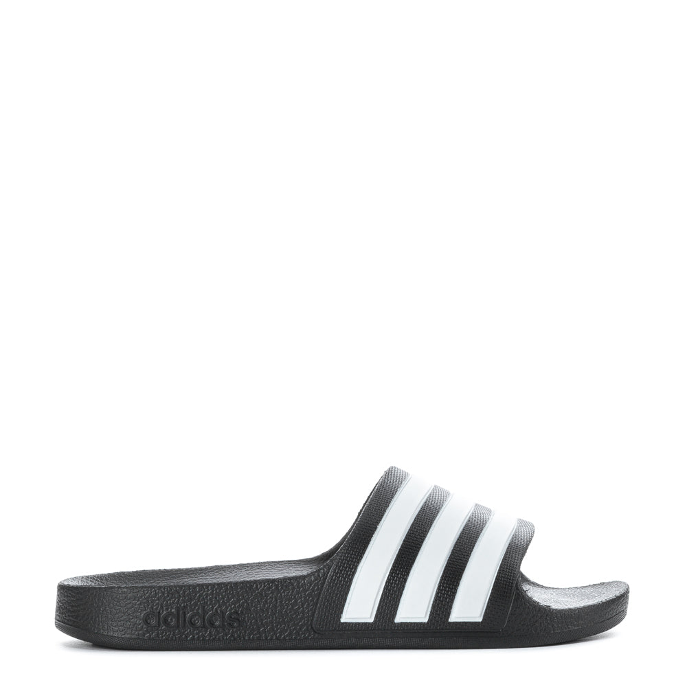 Adidas Adilette Aqua kids slides from the side, highlighting the soft Cloudfoam footbed.