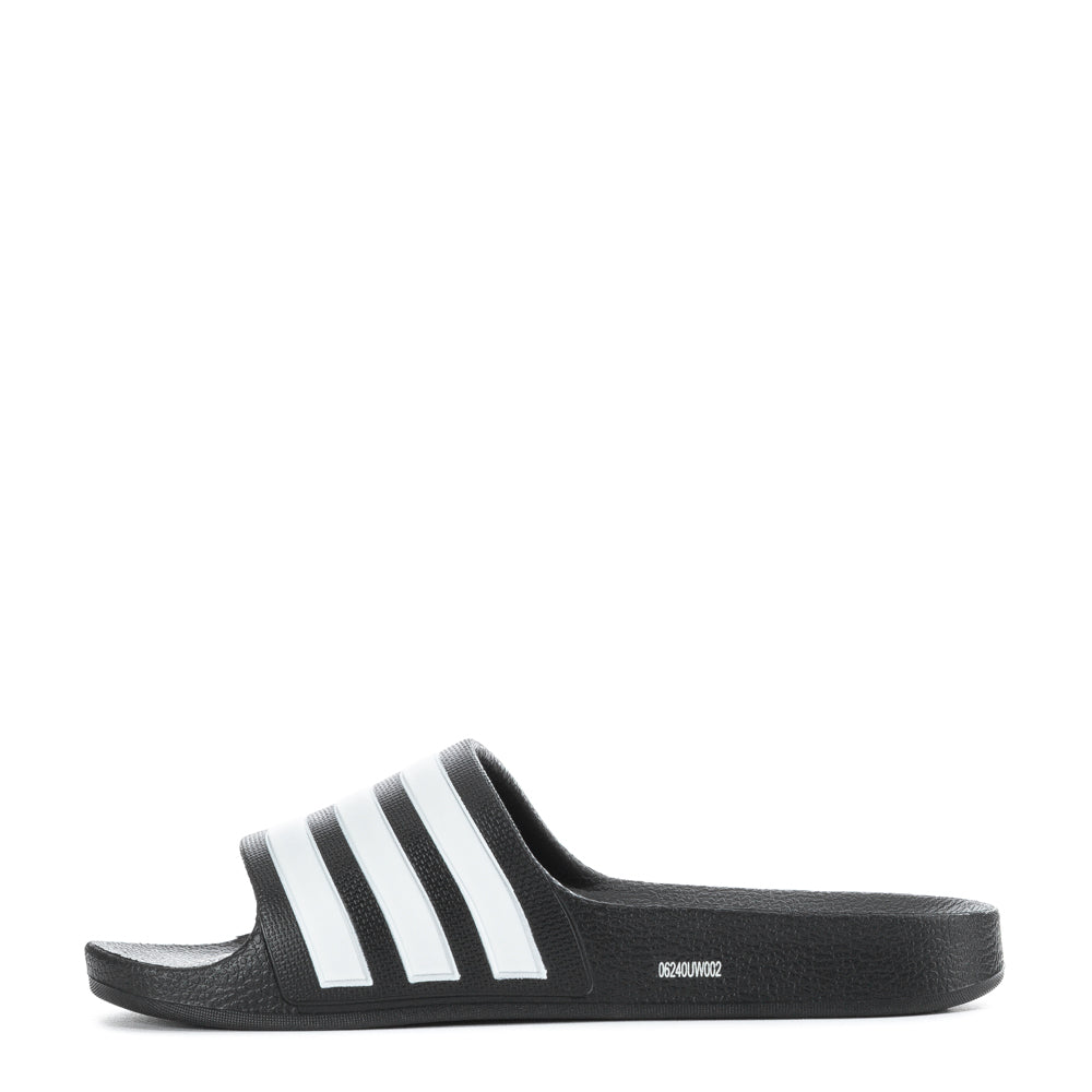 Child wearing Adidas Adilette Aqua slides at the pool, showing their stylish design.