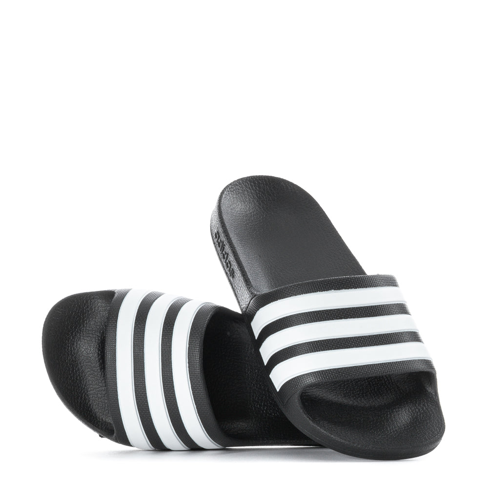 Close-up of Adidas Adilette Aqua slides for kids, focusing on the molded upper and three stripes.