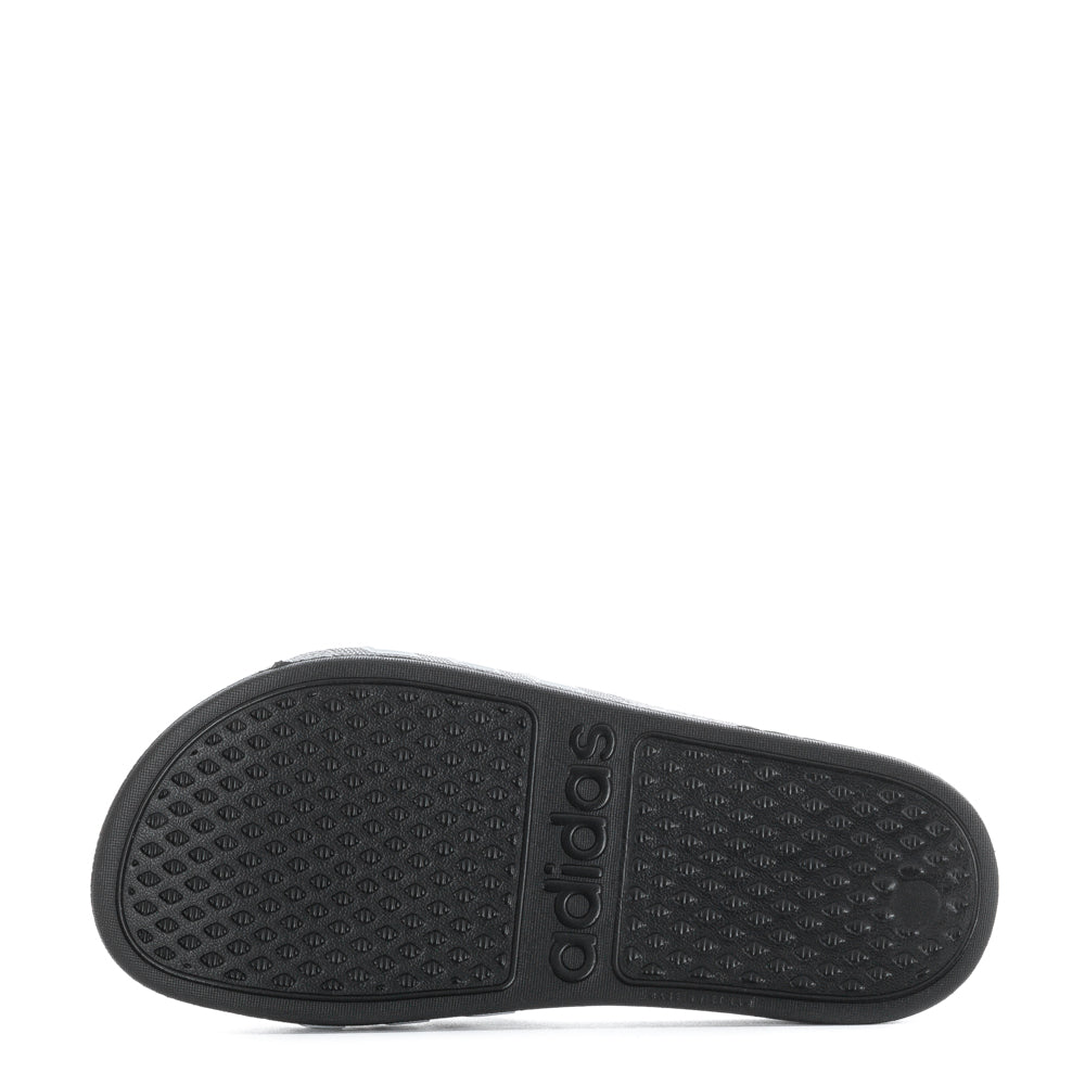 Child wearing Adidas Adilette Aqua slides at the pool, showing their stylish design.
