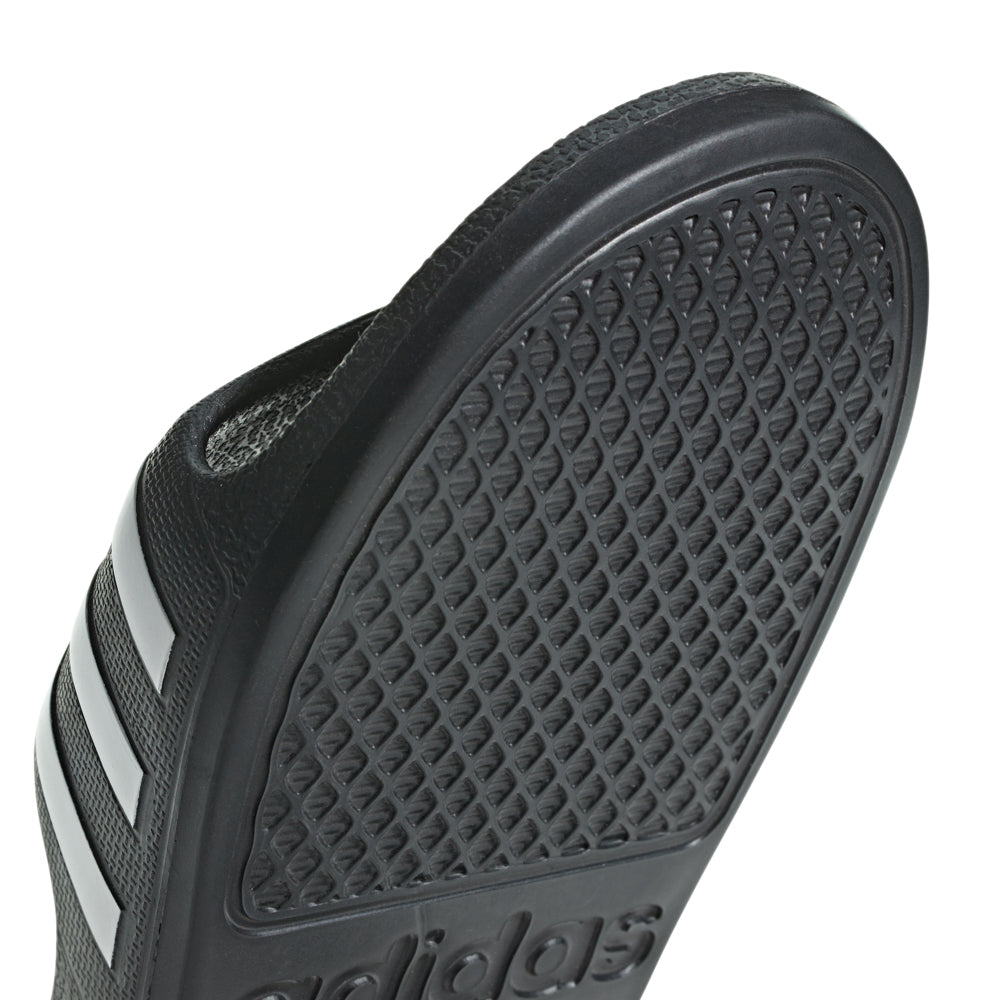 Adidas Adilette Aqua kids slides from the side, highlighting the soft Cloudfoam footbed.