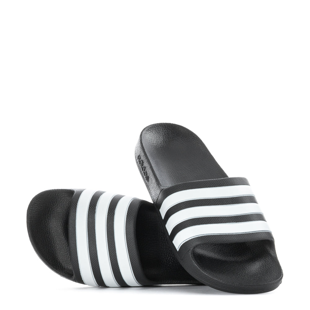 Kids wearing Adidas Aqua Comfort Youth Slides at the pool, enjoying their lightweight and comfortable design.