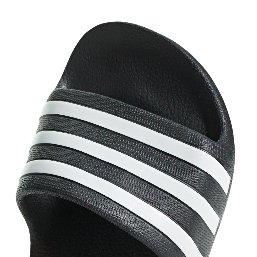 Kids wearing Adidas Aqua Comfort Youth Slides at the pool, enjoying their lightweight and comfortable design.
