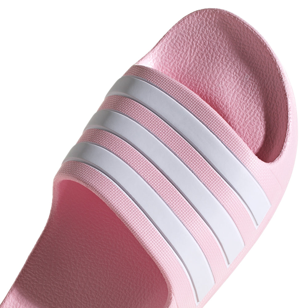 Adidas youth slides worn by kids at the pool, demonstrating their versatility and style.