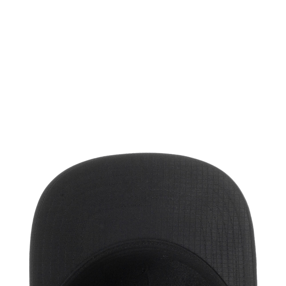 Close-up of rear snapback closure and breathable holes on sports cap