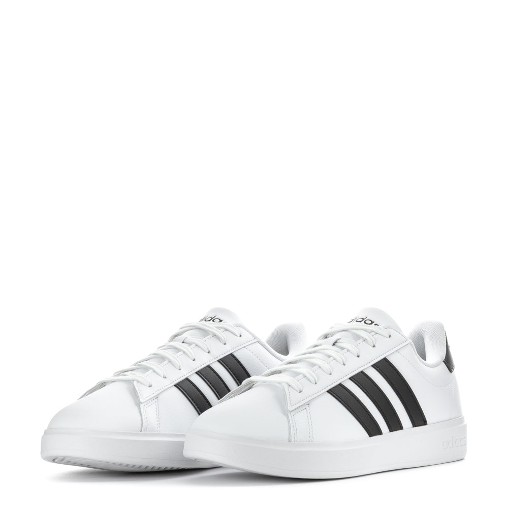 Adidas Grand Court sneakers styled with jeans, showcasing versatility in mens footwear.