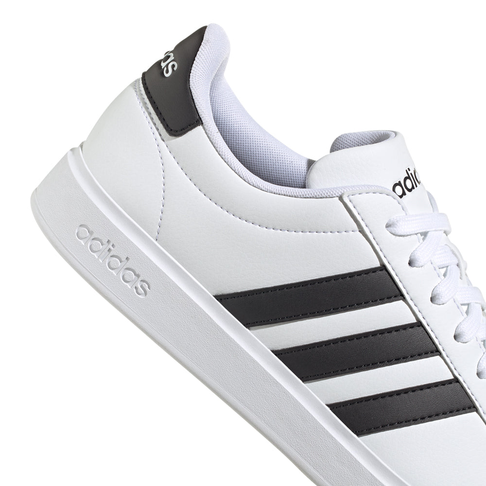 Adidas Grand Court sneakers styled with jeans, showcasing versatility in mens footwear.