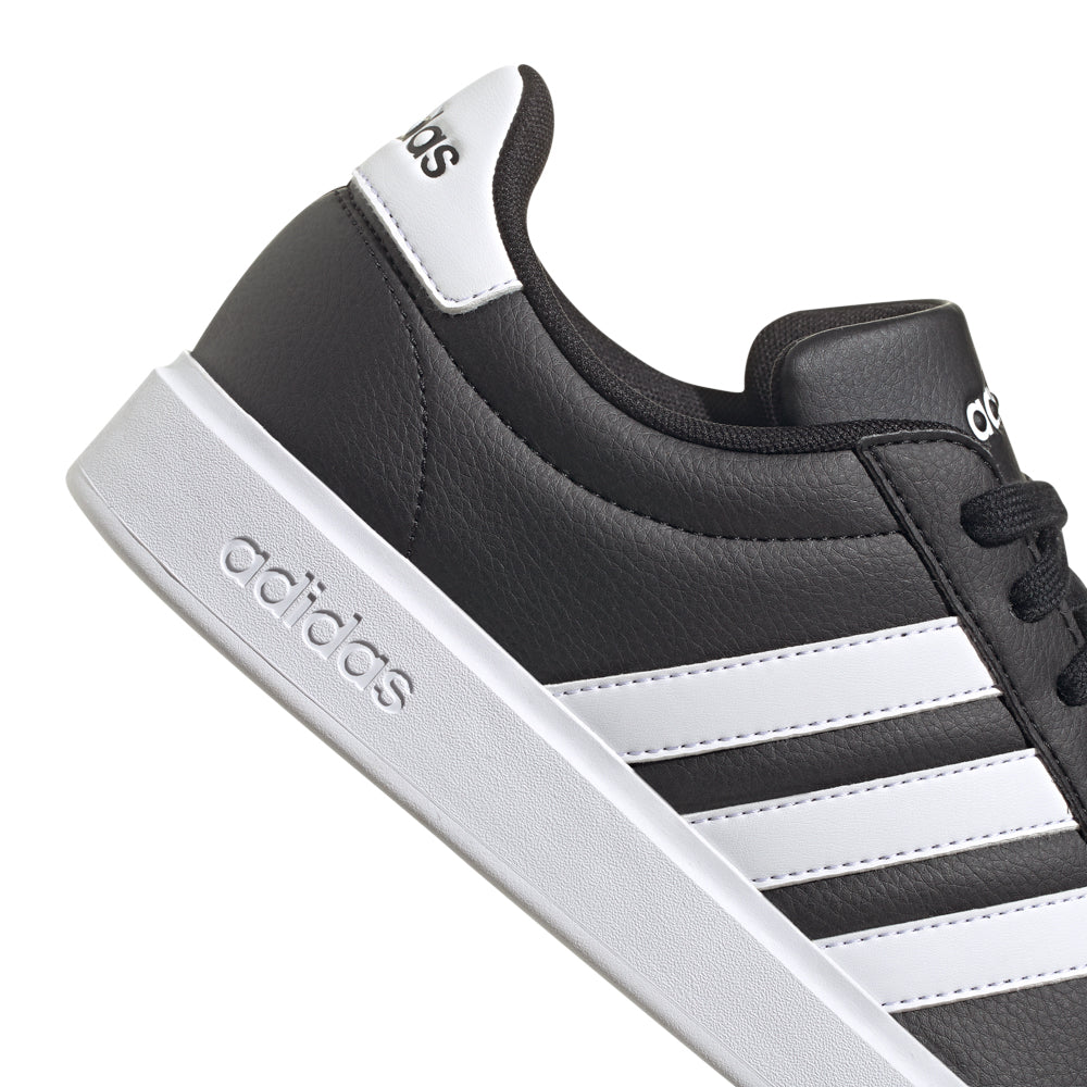 Lifestyle shot of Adidas Grand Court 2.0 worn casually with jeans, emphasizing comfort.