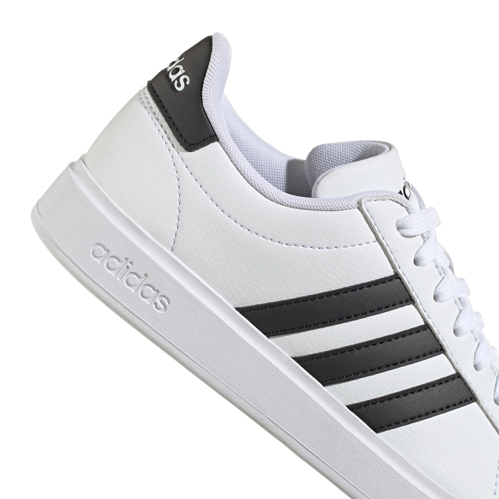 Side view of Adidas Grand Court womens sneakers showcasing their classic design and Cloudfoam Comfort.