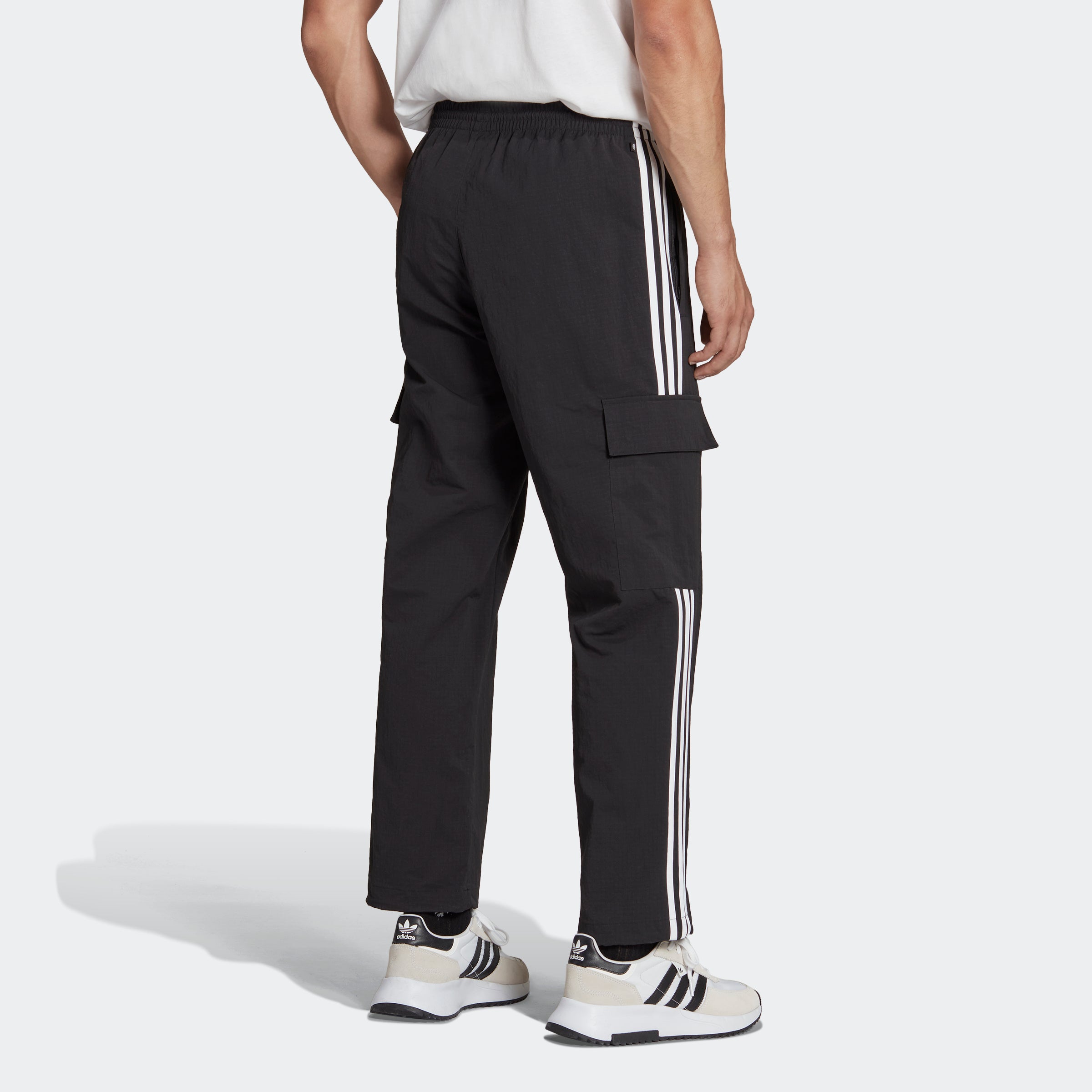 Side view of mens cargo pants with bungee adjustable hems for outdoor use.