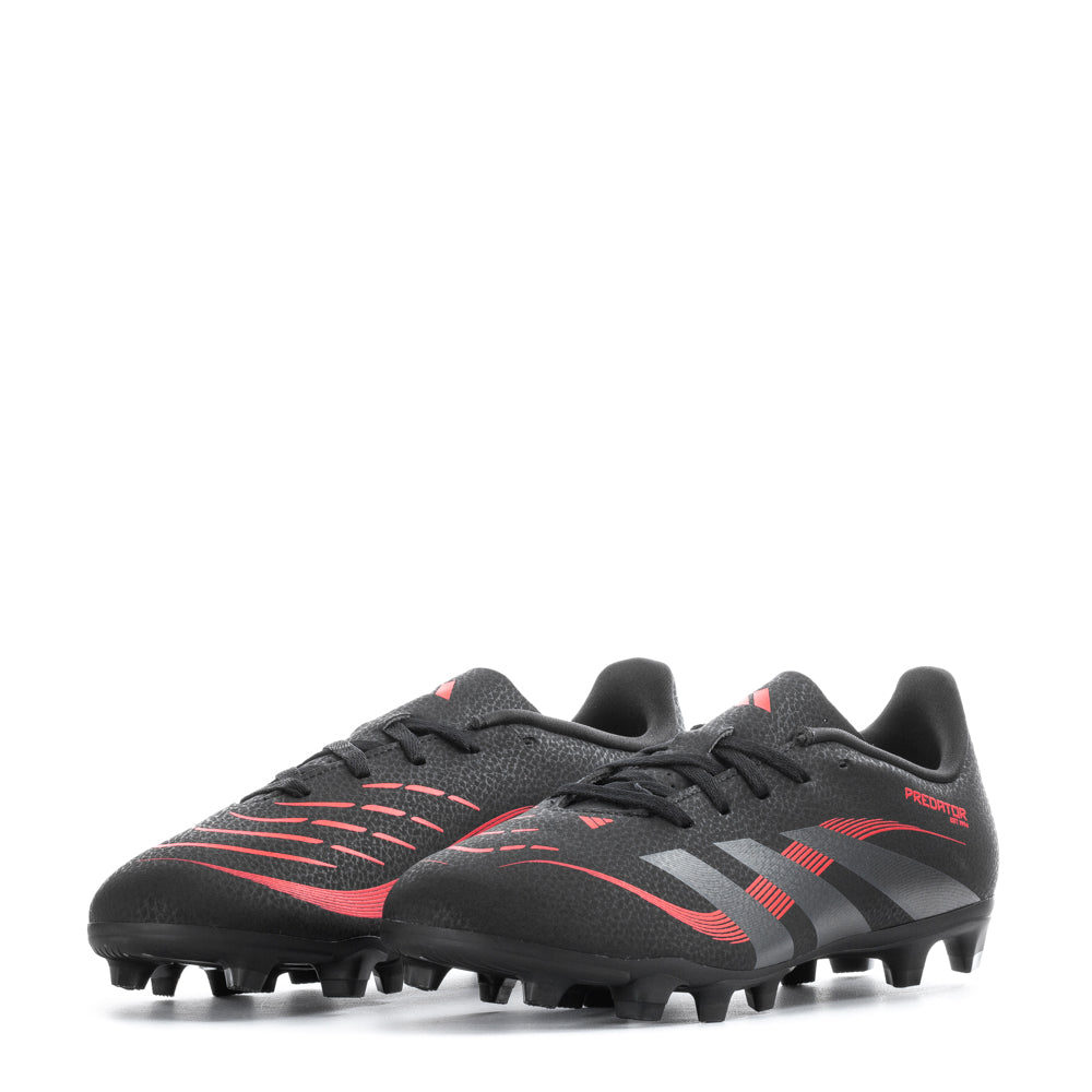 Side view of soccer cleats on artificial turf highlighting cleat pattern
