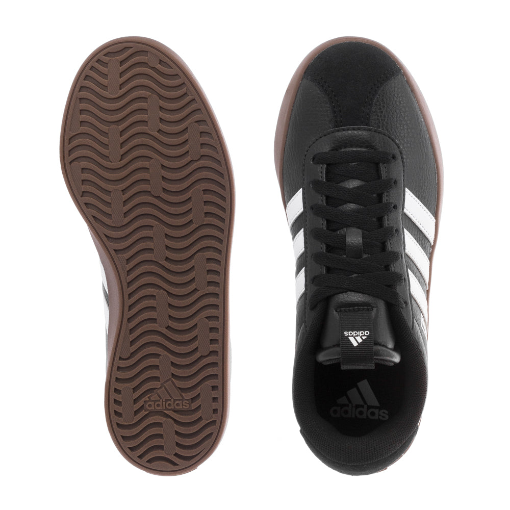 Side angle of white adidas VL Court 3.0 skate shoes resting on a skateboard deck, highlighting vulcanized outsole