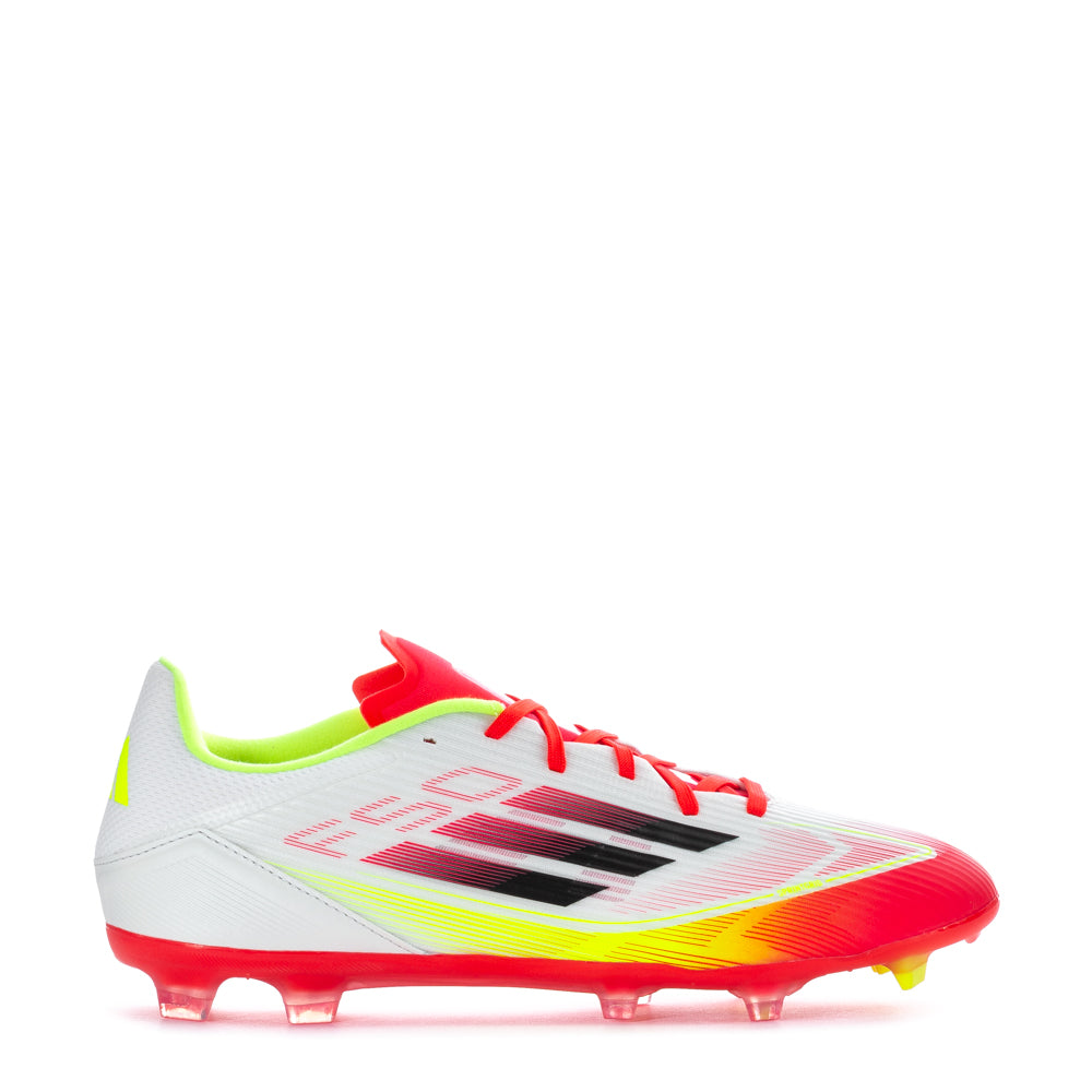 Side view of Adidas F50 League Low FGxMG soccer cleats on a grassy field, highlighting their lightweight design.