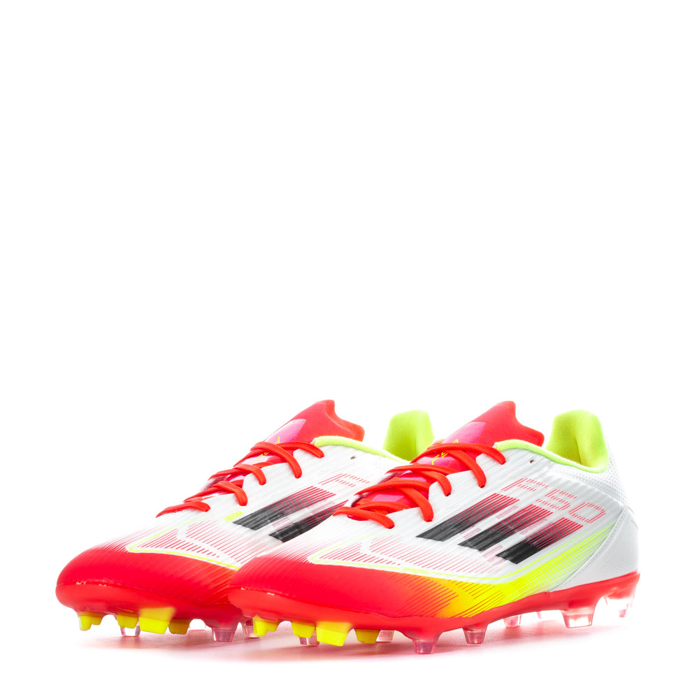 Action shot of a player wearing Adidas F50 League Low FGxMG soccer cleats, demonstrating grip and speed on the field.