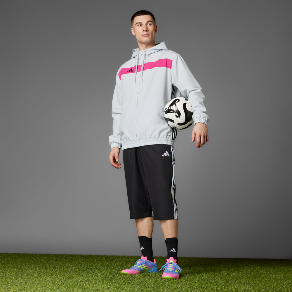 Top-down shot of adidas cleats highlighting the stretchable tunnel tongue and outsole design