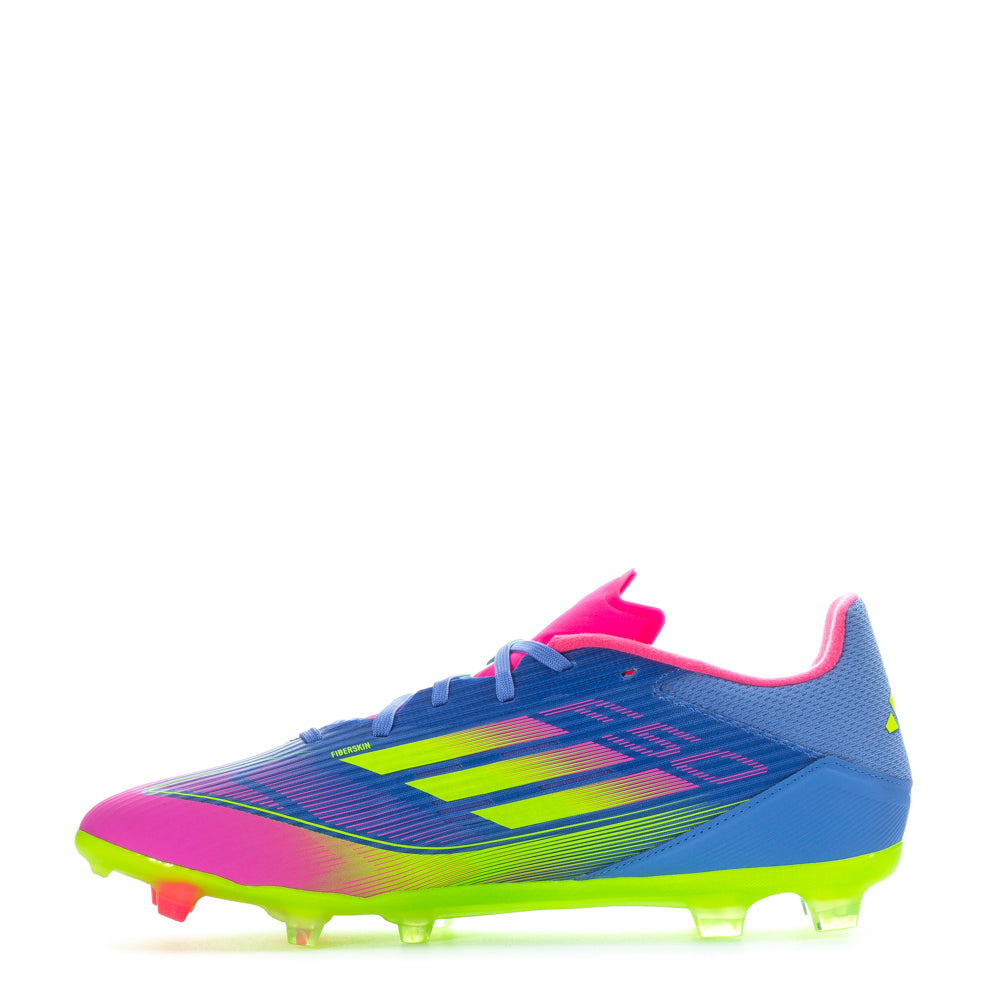 Close-up of adidas F50 League Low FGxMG mens soccer cleats showing stud configuration on dry grass