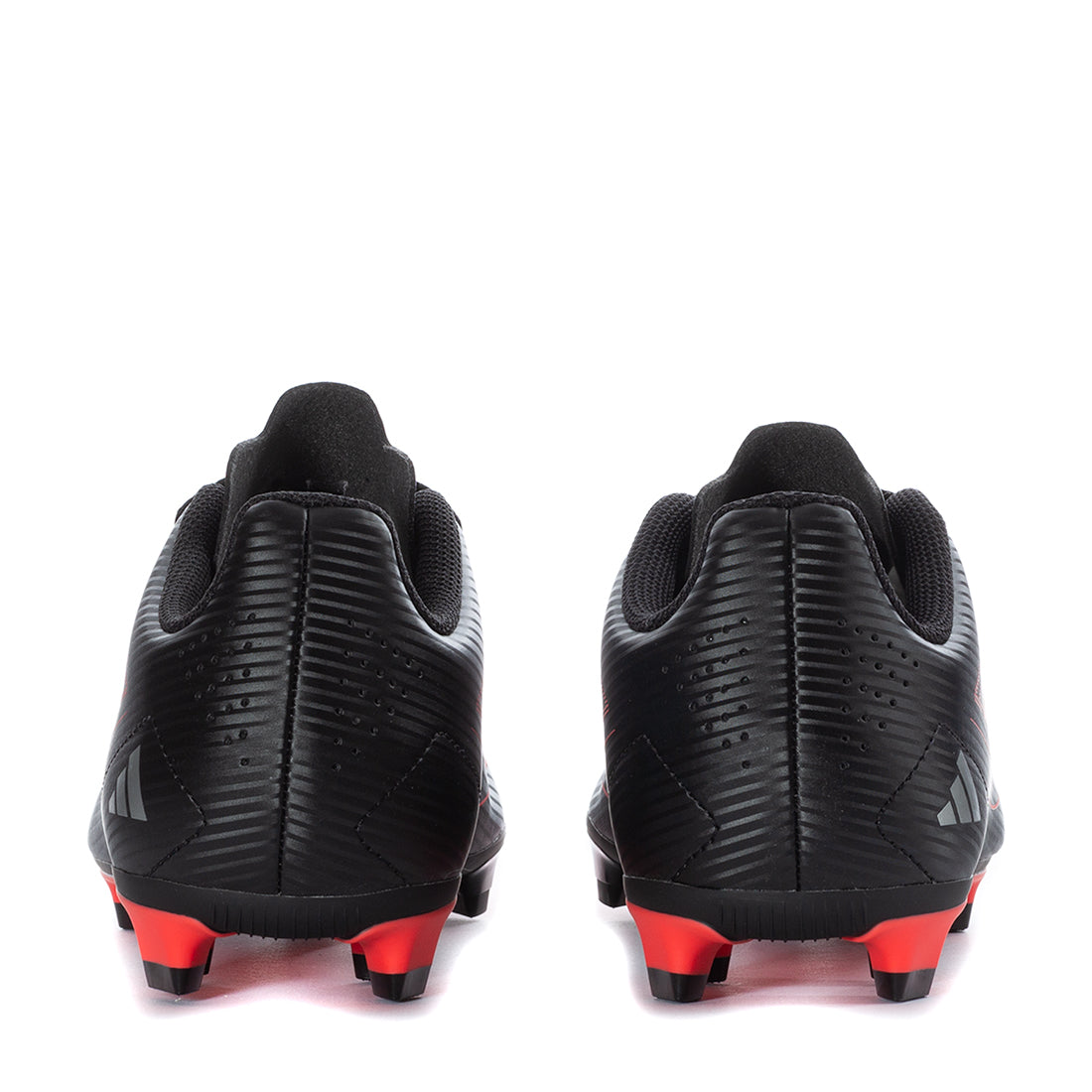 Close-up of the Adidas F50 cleats highlighting the traction studs, perfect for firm ground soccer play.