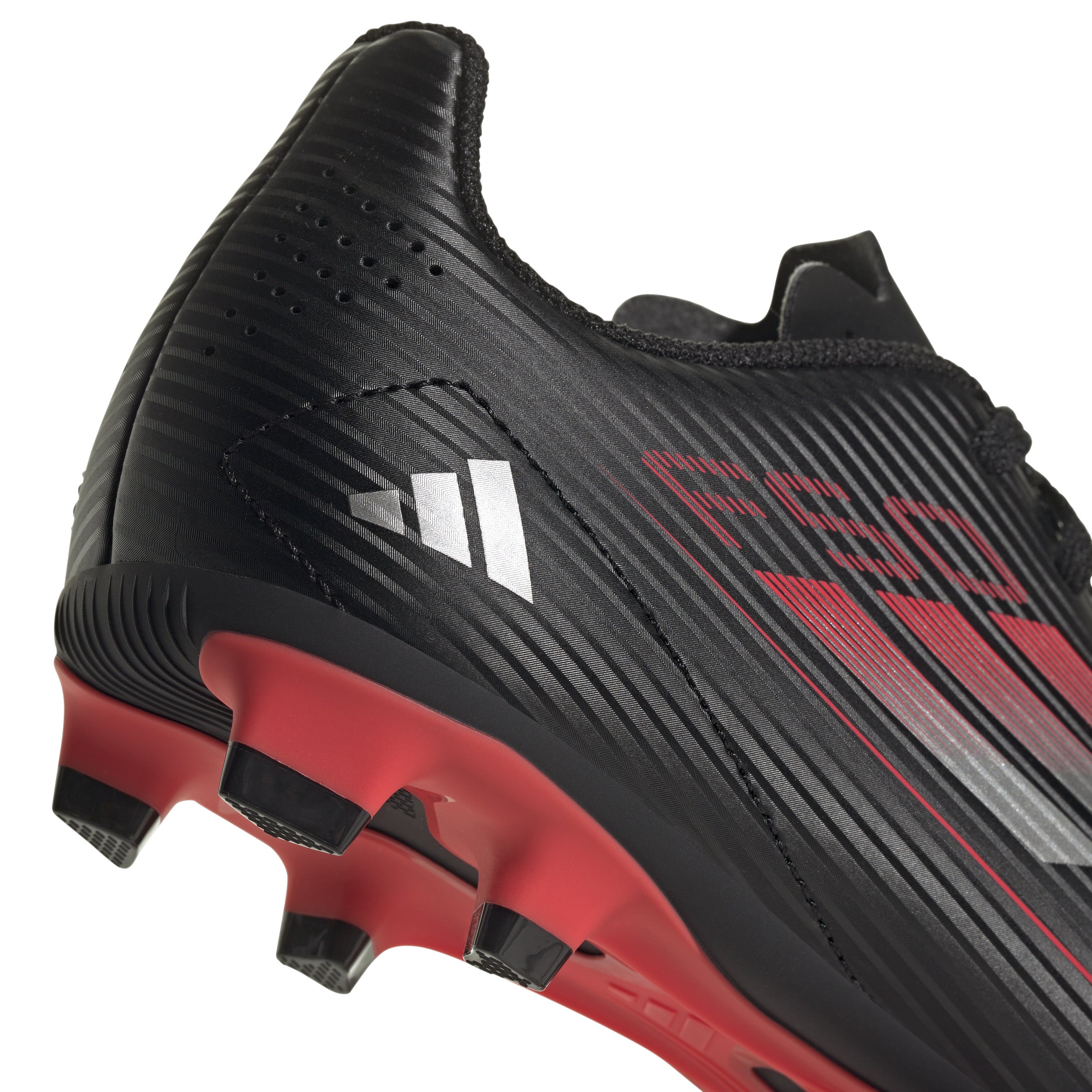 Adidas F50 Club FG Youth Soccer Cleats showcasing their sleek black design and comfortable fit, ideal for practice.