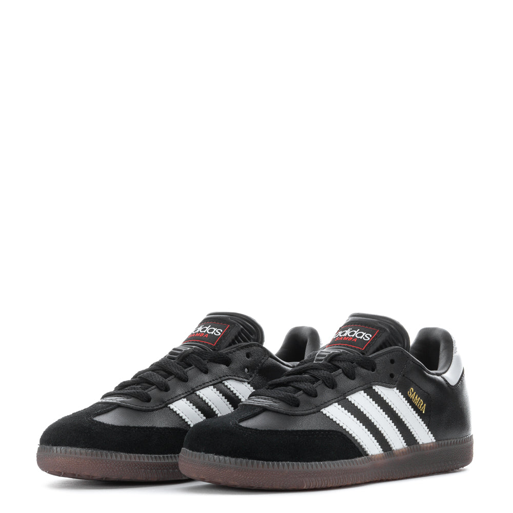 Adidas Samba Classic kids soccer shoes, worn during a practice session on the field.