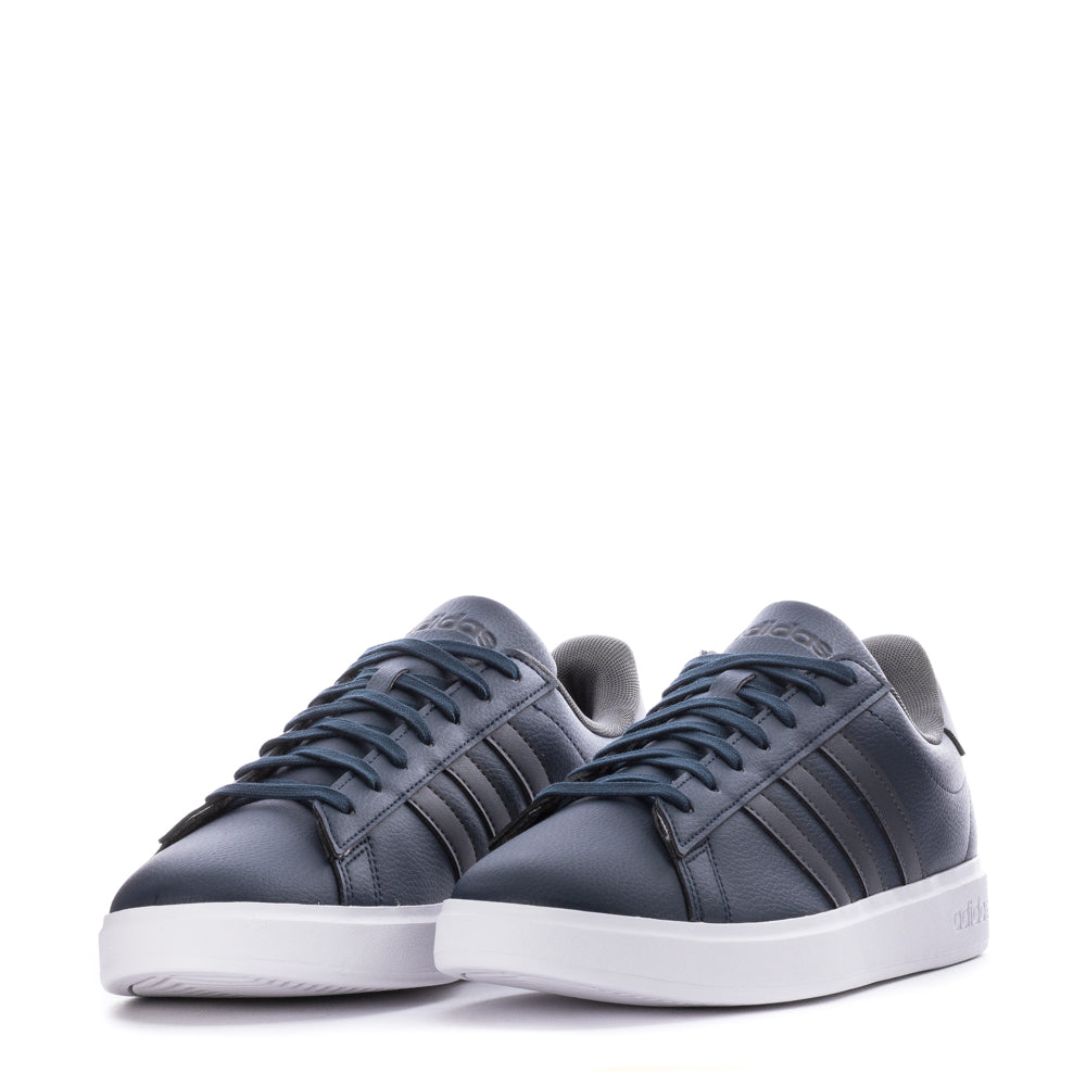 Men wearing Adidas Grand Court 2.0 sneakers in a casual setting, highlighting their versatility and style.
