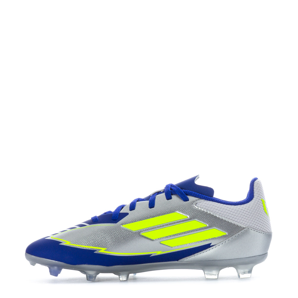Close-up of the F50 League FG Messi youth football boots on grass field