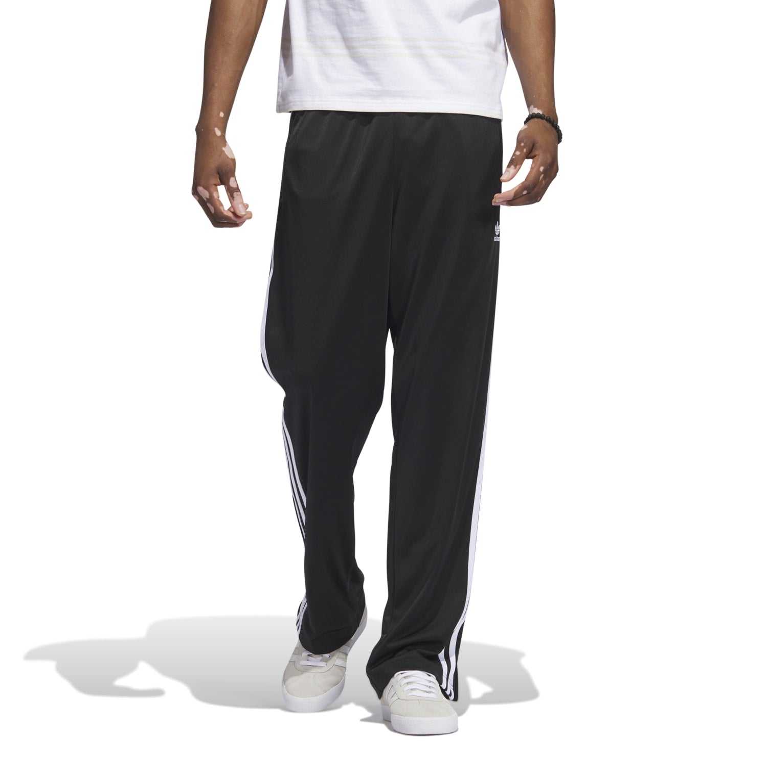 Close-up of lightweight recycled polyester fabric texture against city backdrop, highlighting durability of track pants