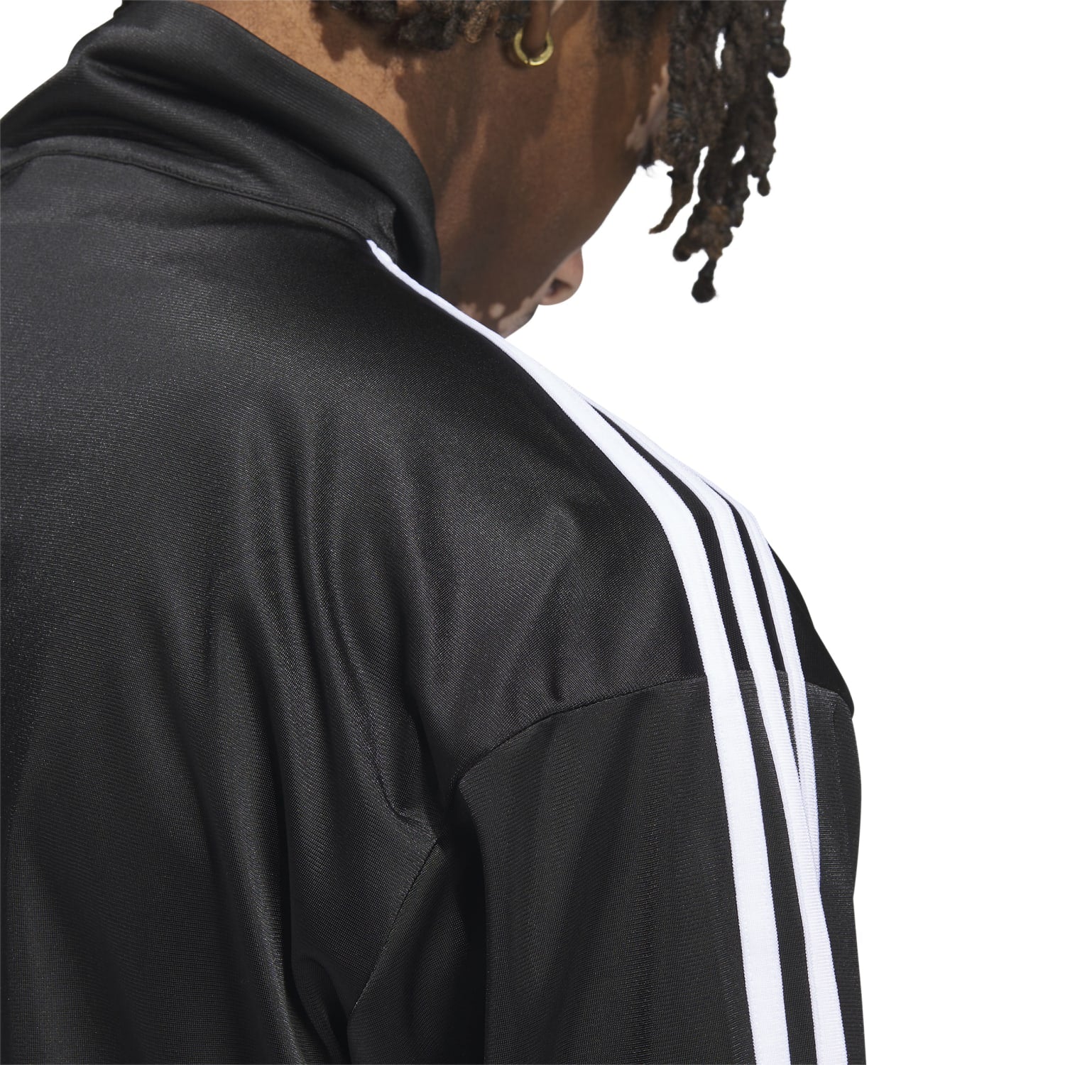Close-up of the zip-up front and fitted cuffs of a mens track jacket
