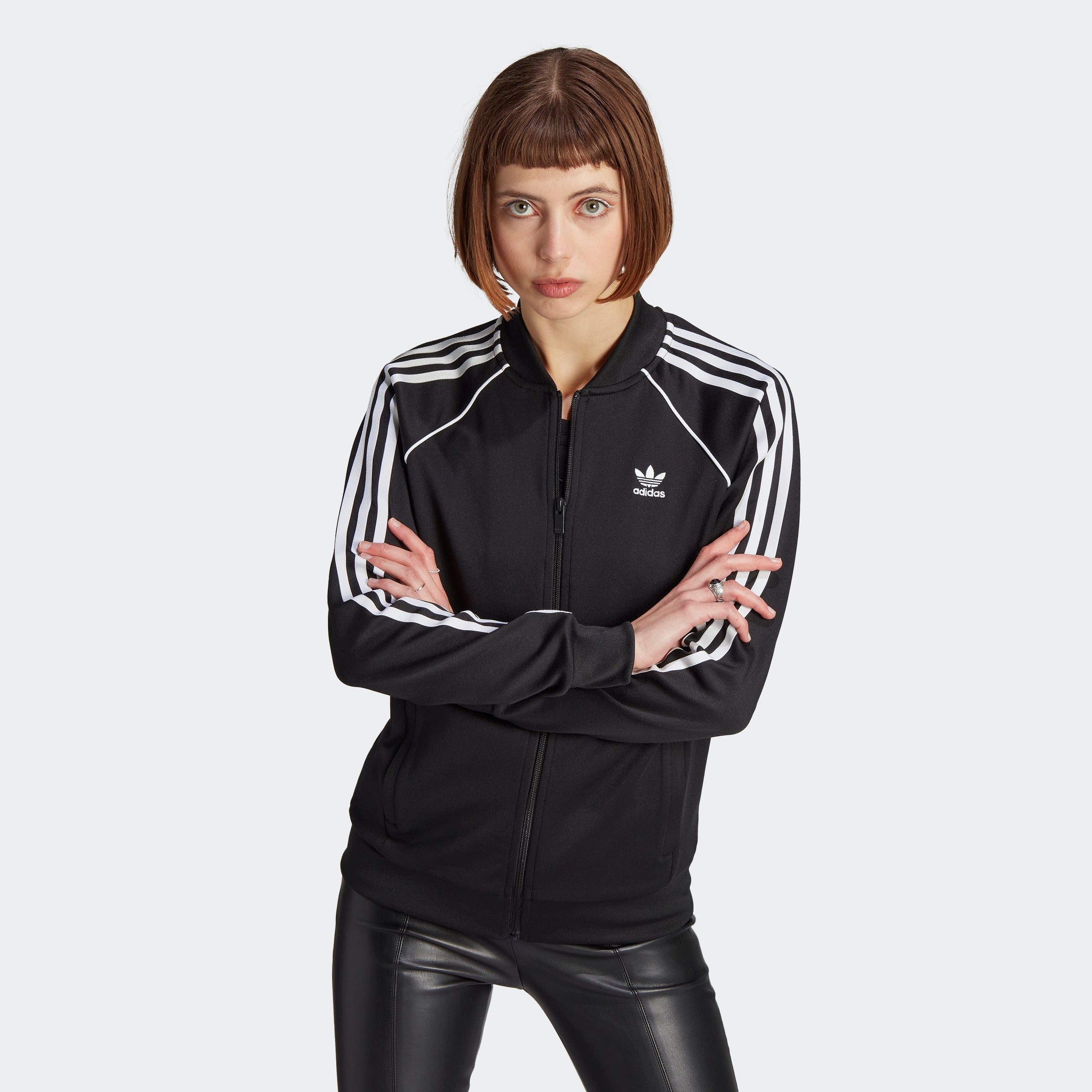 Close-up of the Adidas Superstar track jacket detailing, emphasizing the high-quality stitching and fabric.