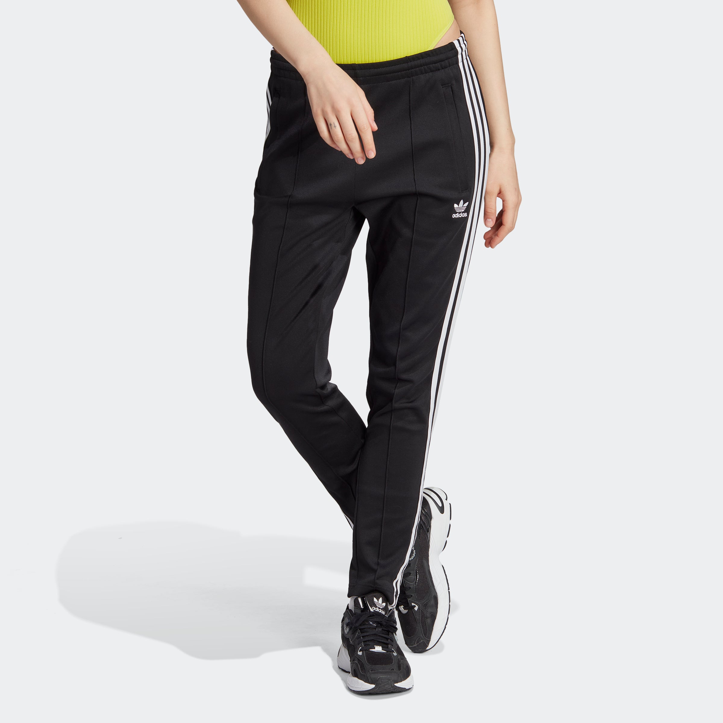Adidas womens slim fit track pants shown from the front, ideal for activewear.