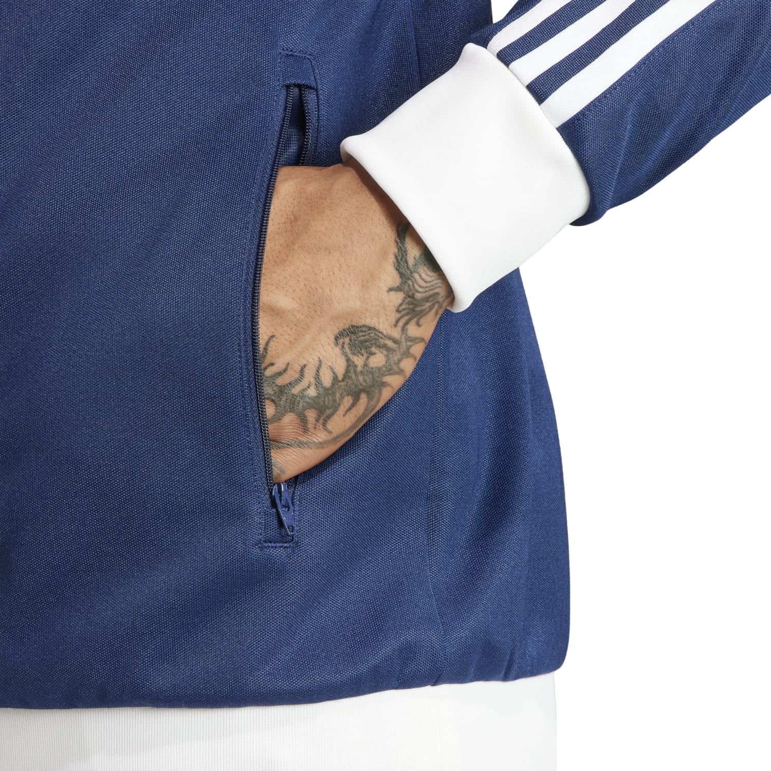 Close-up of the Adidas jackets three stripes, highlighting its classic style.