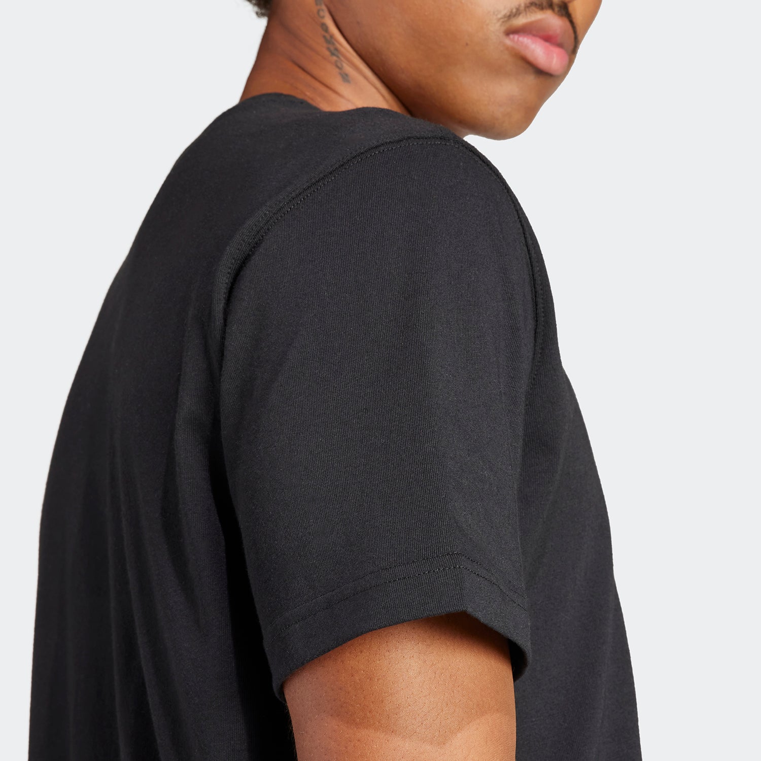 Close-up of ribbed crewneck on cotton mens T-shirt