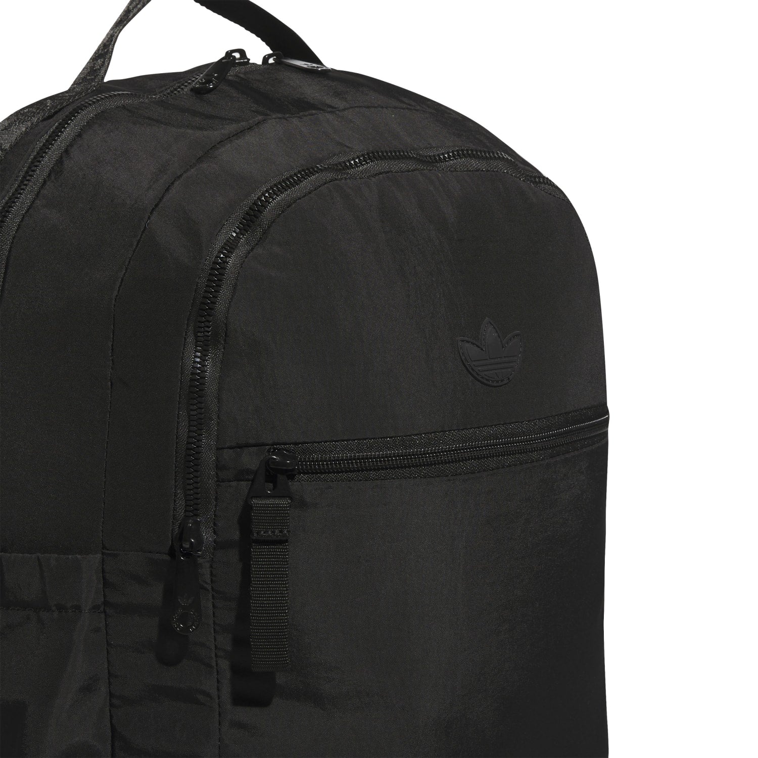 Close-up of padded shoulder straps and luggage-handle passthrough on a Luna Originals backpack