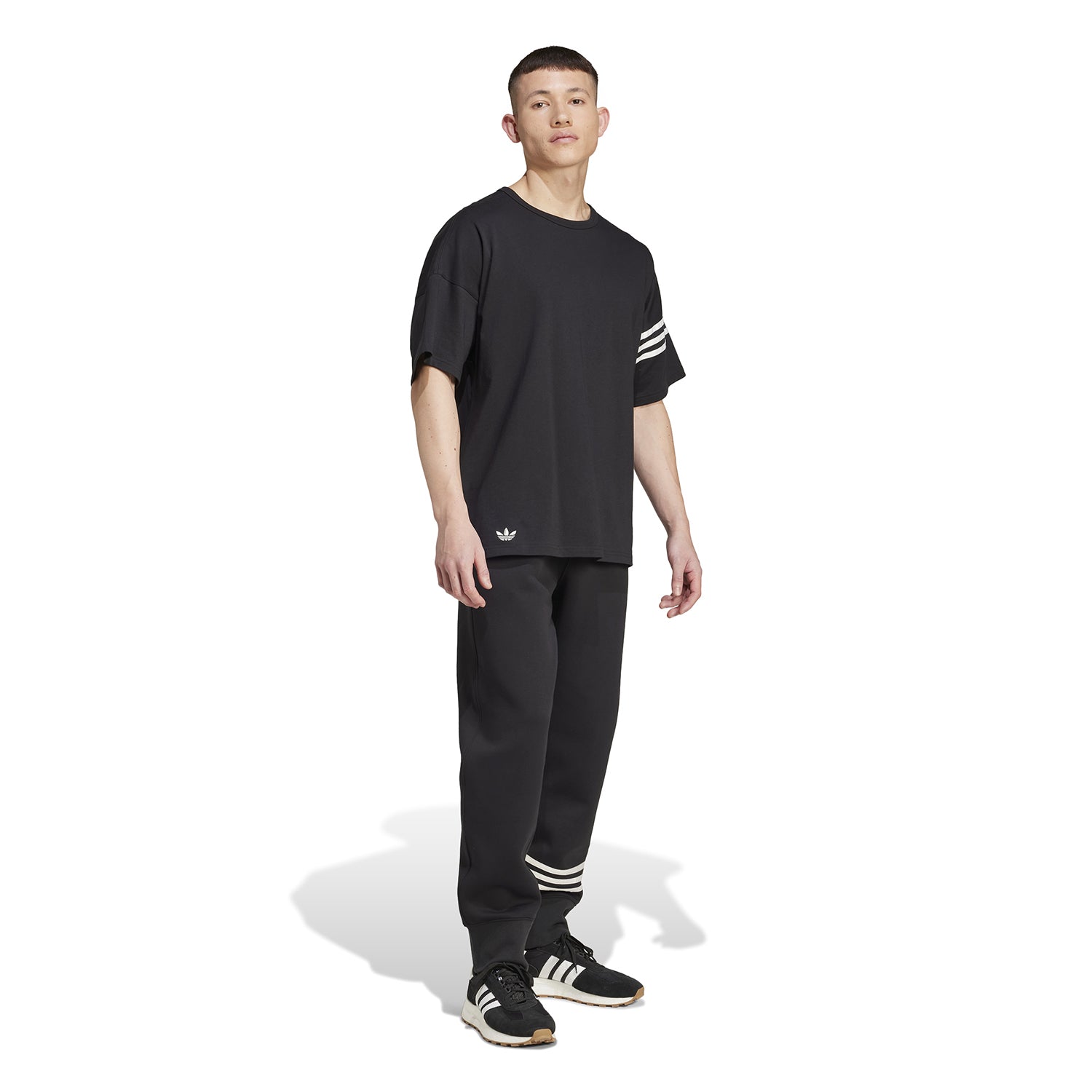 Casual styling of the Adidas mens t-shirt paired with shorts, perfect for summer outings.