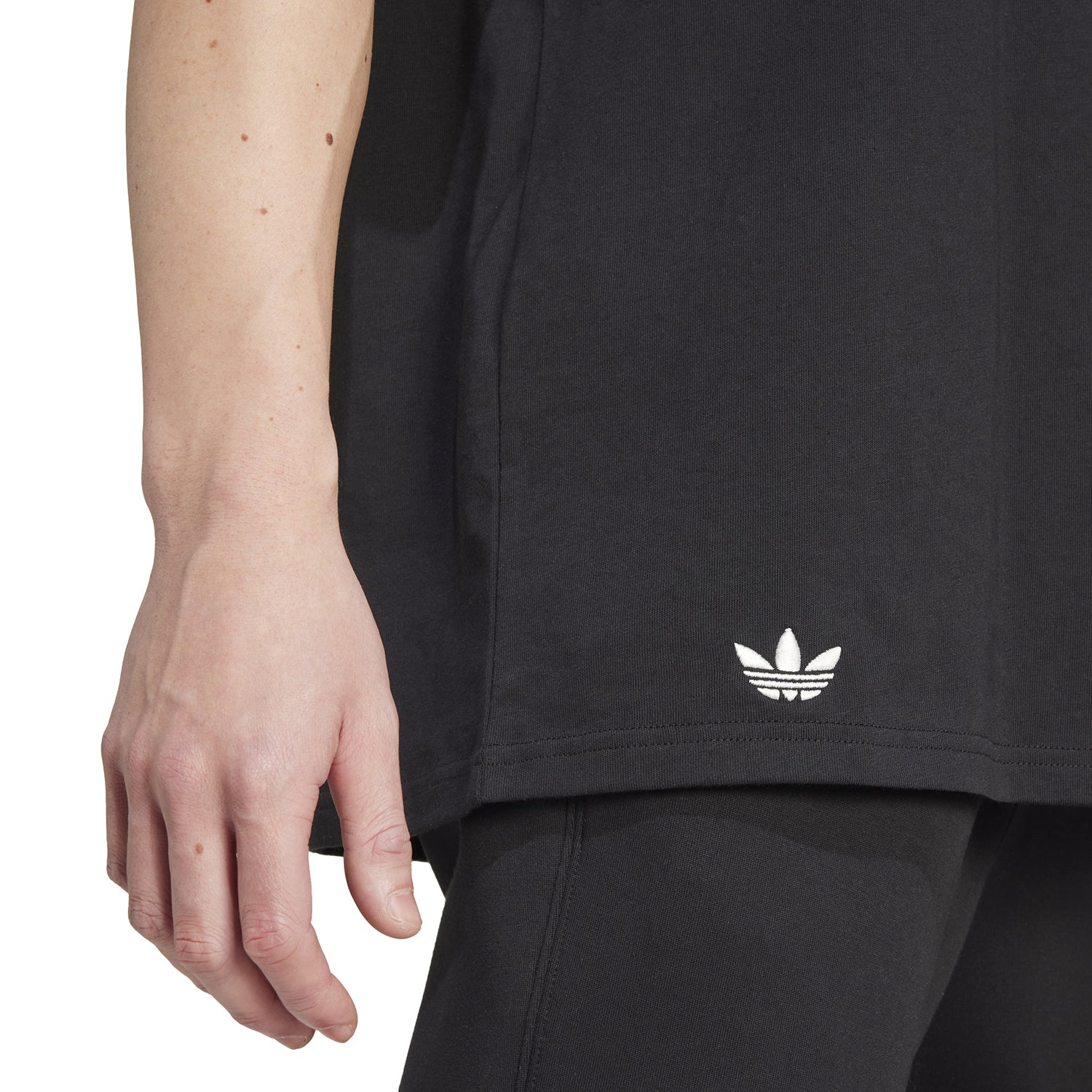 Close-up of the Adidas Neu Classics tee, highlighting the striped sleeve design and Trefoil logo.