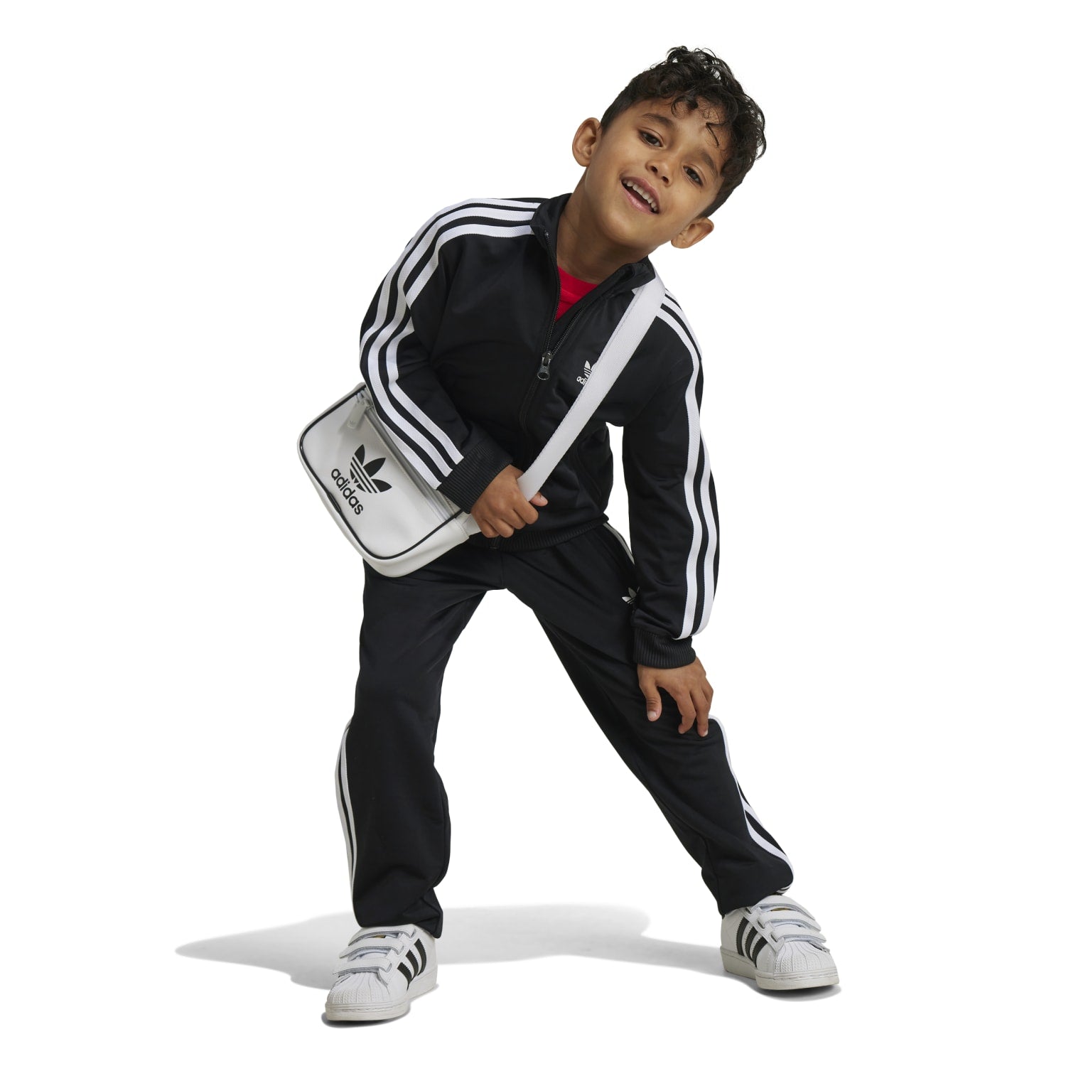 Close-up of the zip-up jacket with stand collar from the Adidas Firebird Kids Track Set.