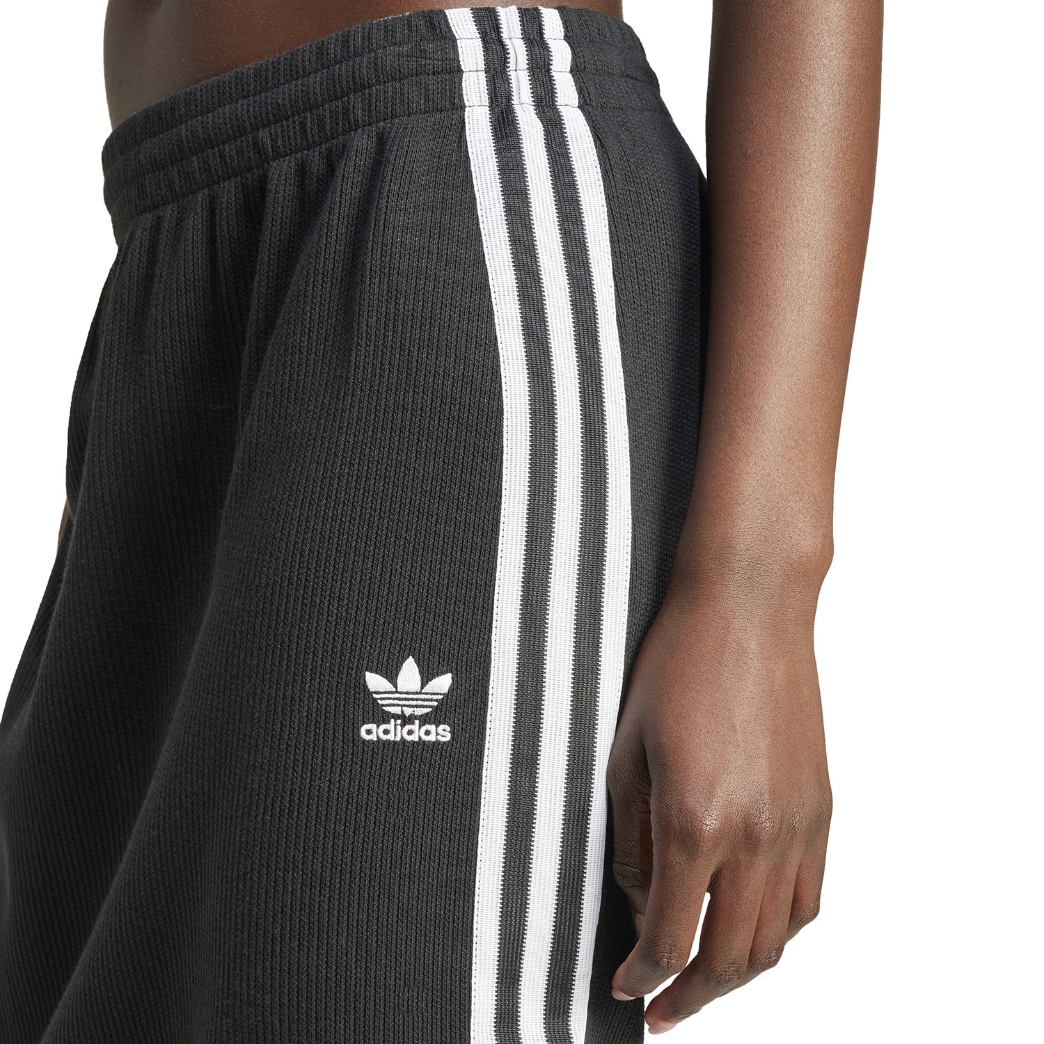 Side view of Adidas womens knitted skirt showcasing elastic waistband, perfect for athletic wear.