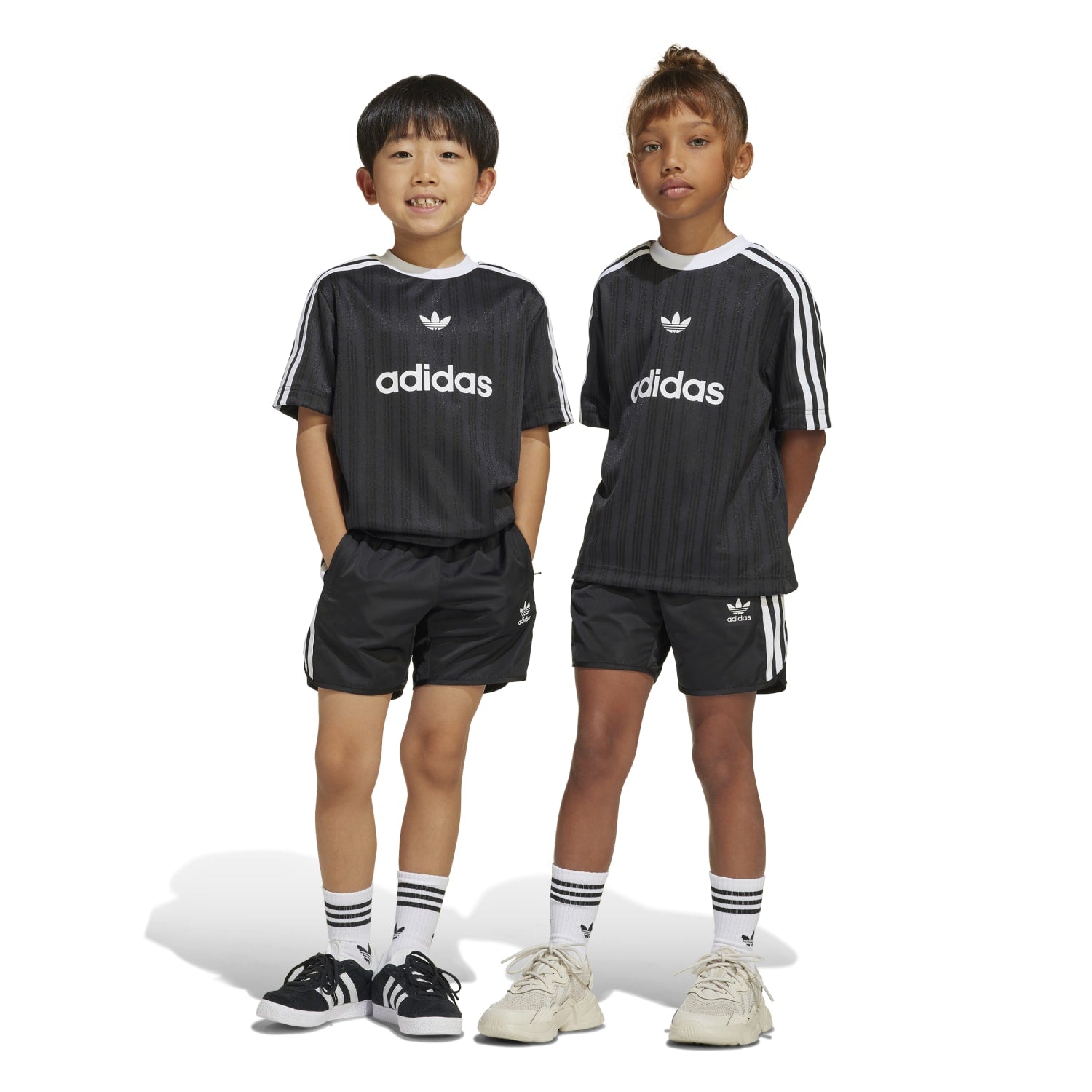 Close-up of a youth football tee with ball and pump, suitable for beginner players.