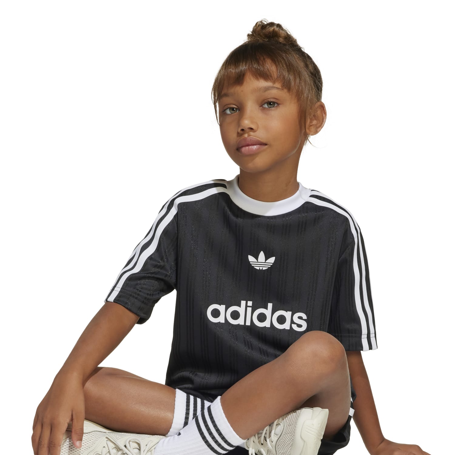 Close-up of a youth football tee with ball and pump, suitable for beginner players.