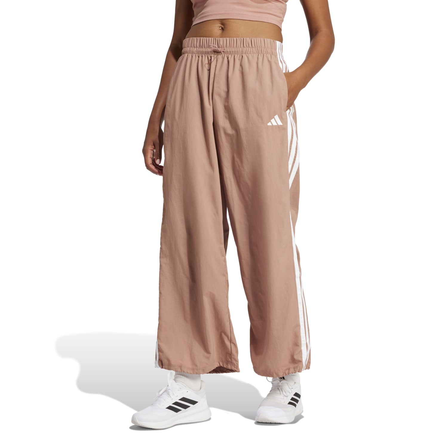Side view of the Adidas parachute pants, showcasing the elastic waistband and bungee closure.