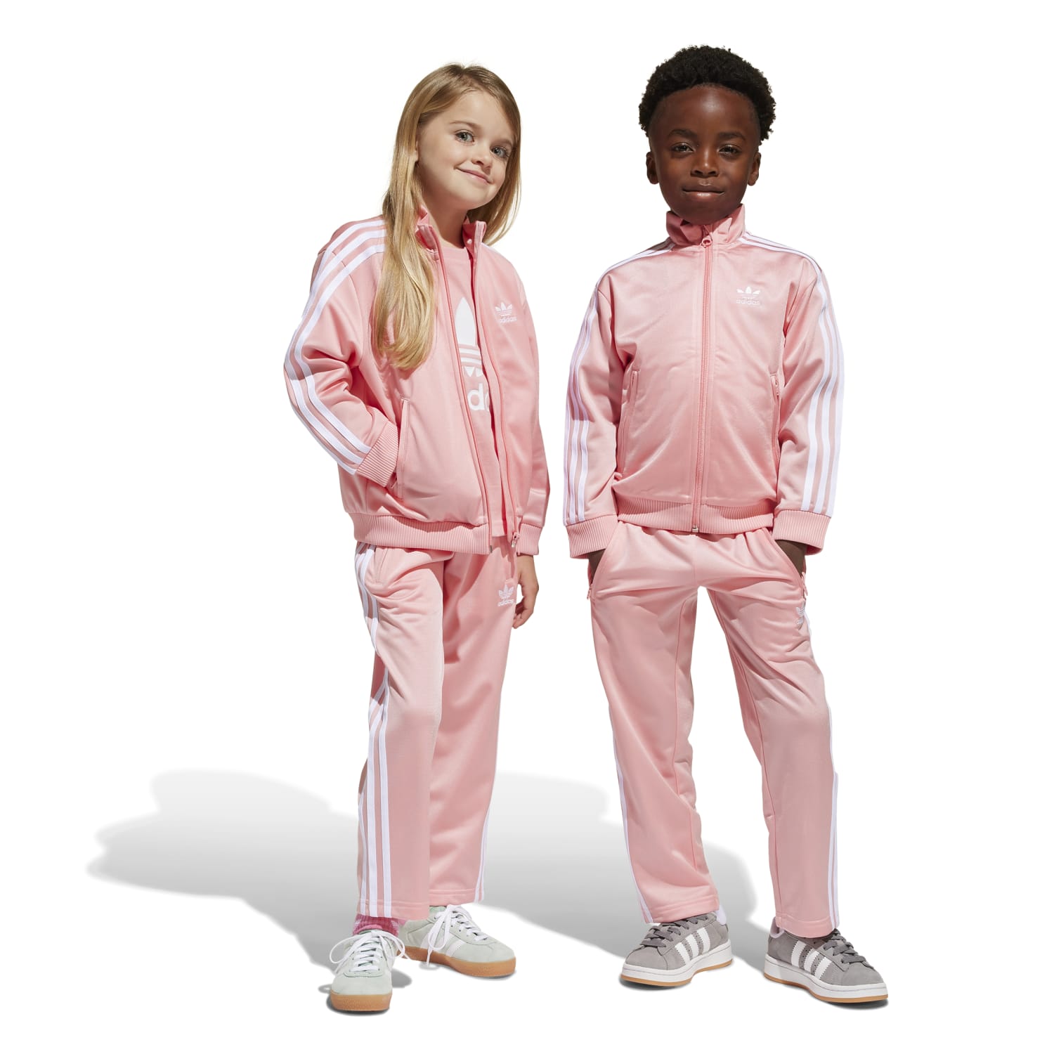 Close-up of kids athletic clothing featuring signature three stripes