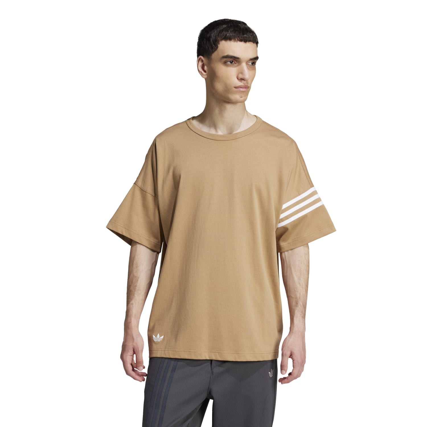 Side angle of the Adidas tee, emphasizing its relaxed fit and Trefoil logo.