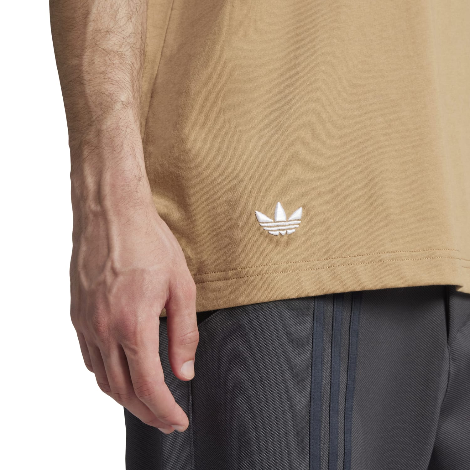 Side angle of the Adidas tee, emphasizing its relaxed fit and Trefoil logo.