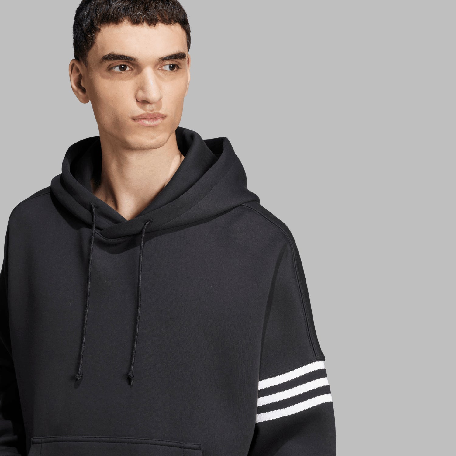 Close-up of Adidas Neuclassics hoodie with 3-stripes design showing serrated edges