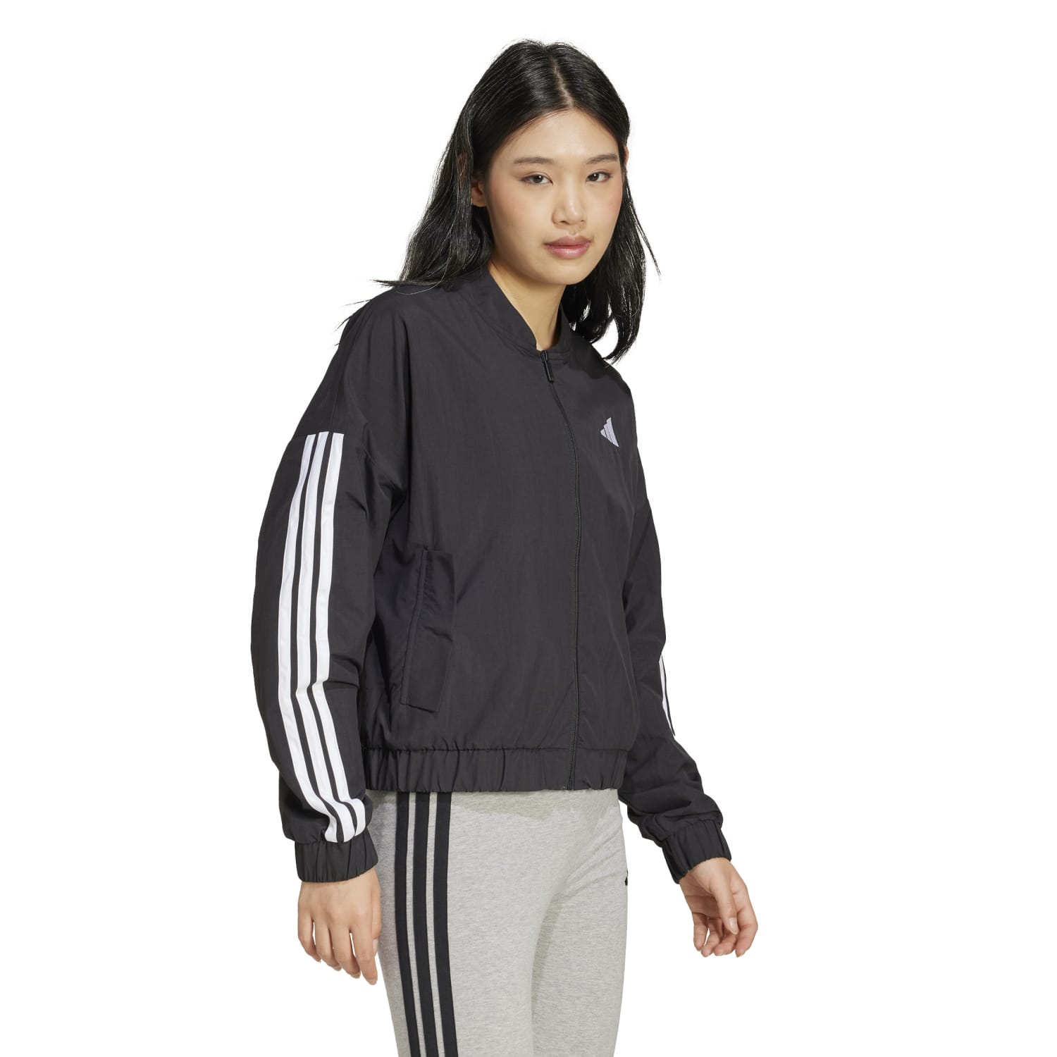 Front view of eco-friendly womens recycled bomber jacket showing the adidas three-stripe logo