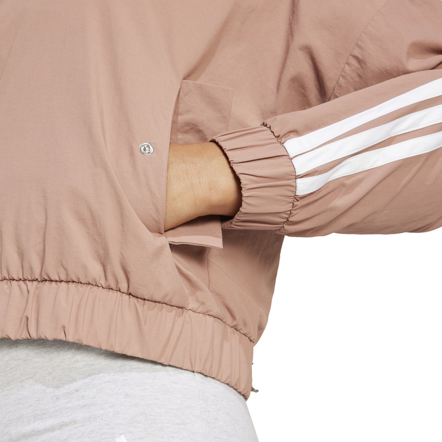 Lightweight windbreaker for women, featuring the adidas three-stripe logo, perfect for casual wear.