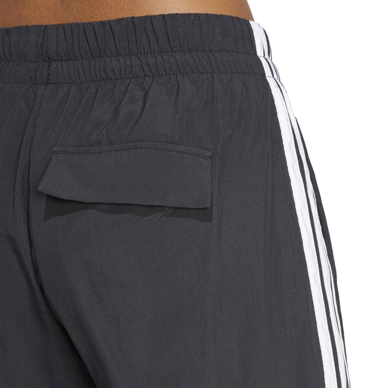 Front view of womens Adidas parachute pants showcasing wide leg design.