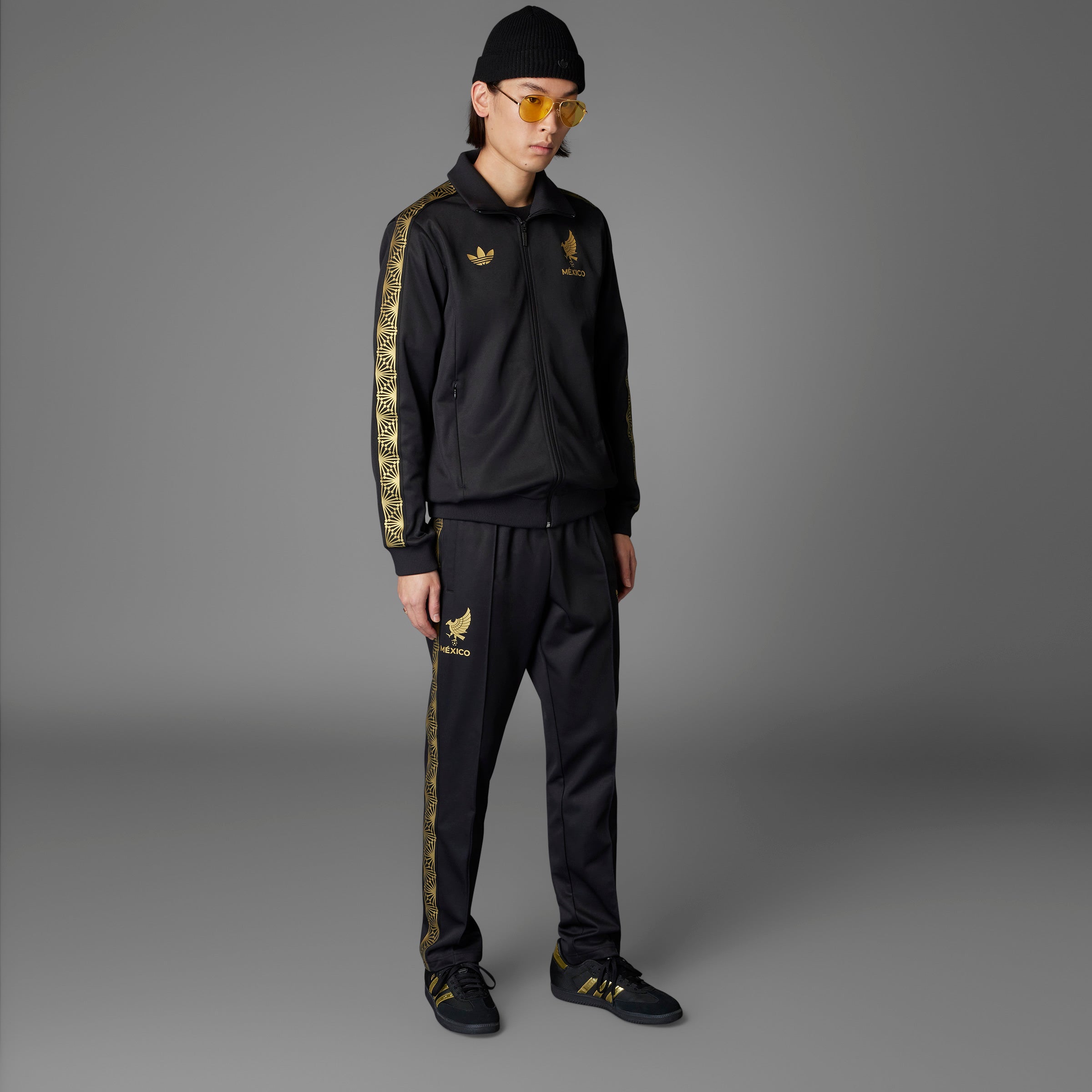 Model wearing the Adidas Mexico Heritage Track Jacket during a football match, emphasizing its sporty appeal.