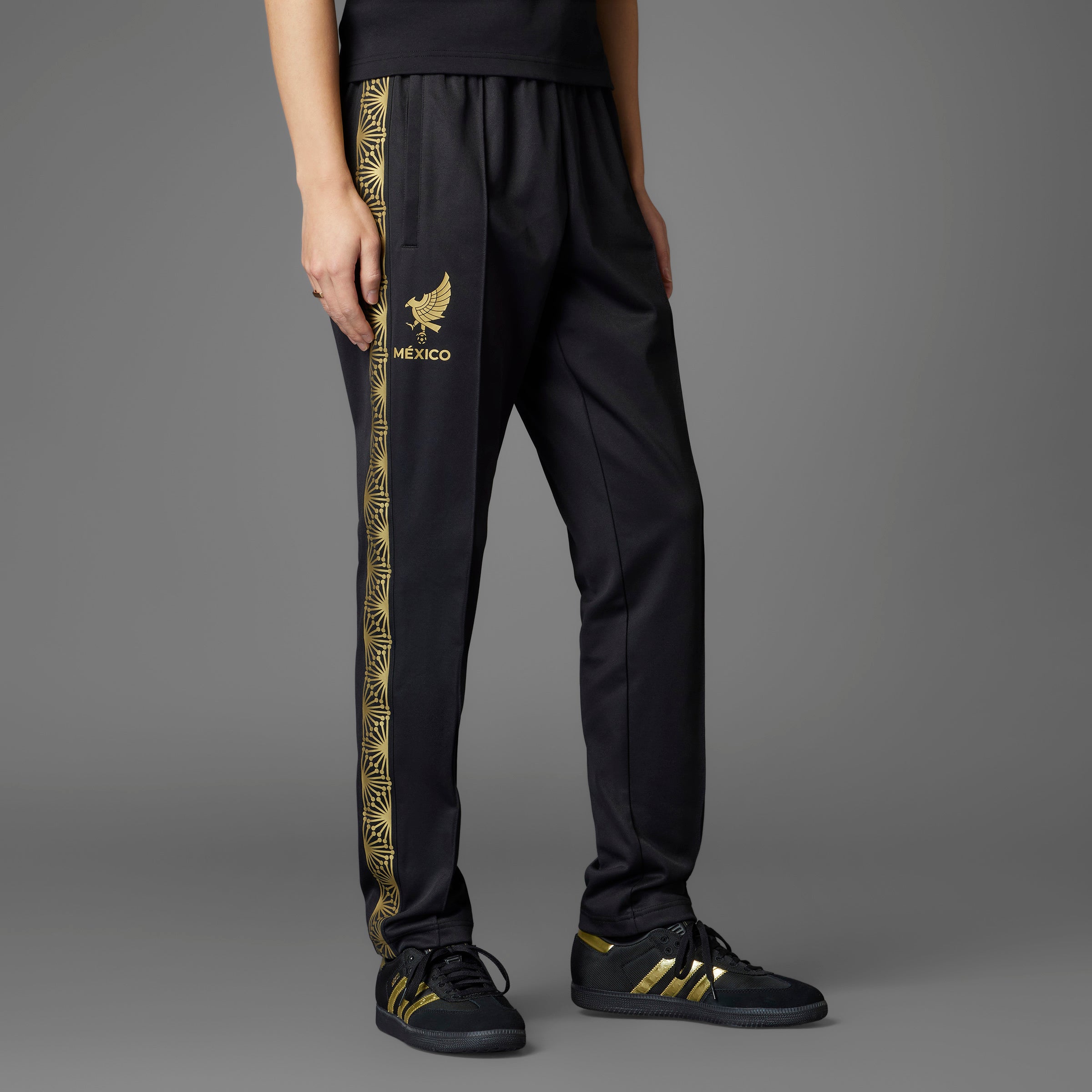 Close-up of the Adidas Mexico soccer track pants showcasing the Trefoil logo and elastic waist with drawcord.