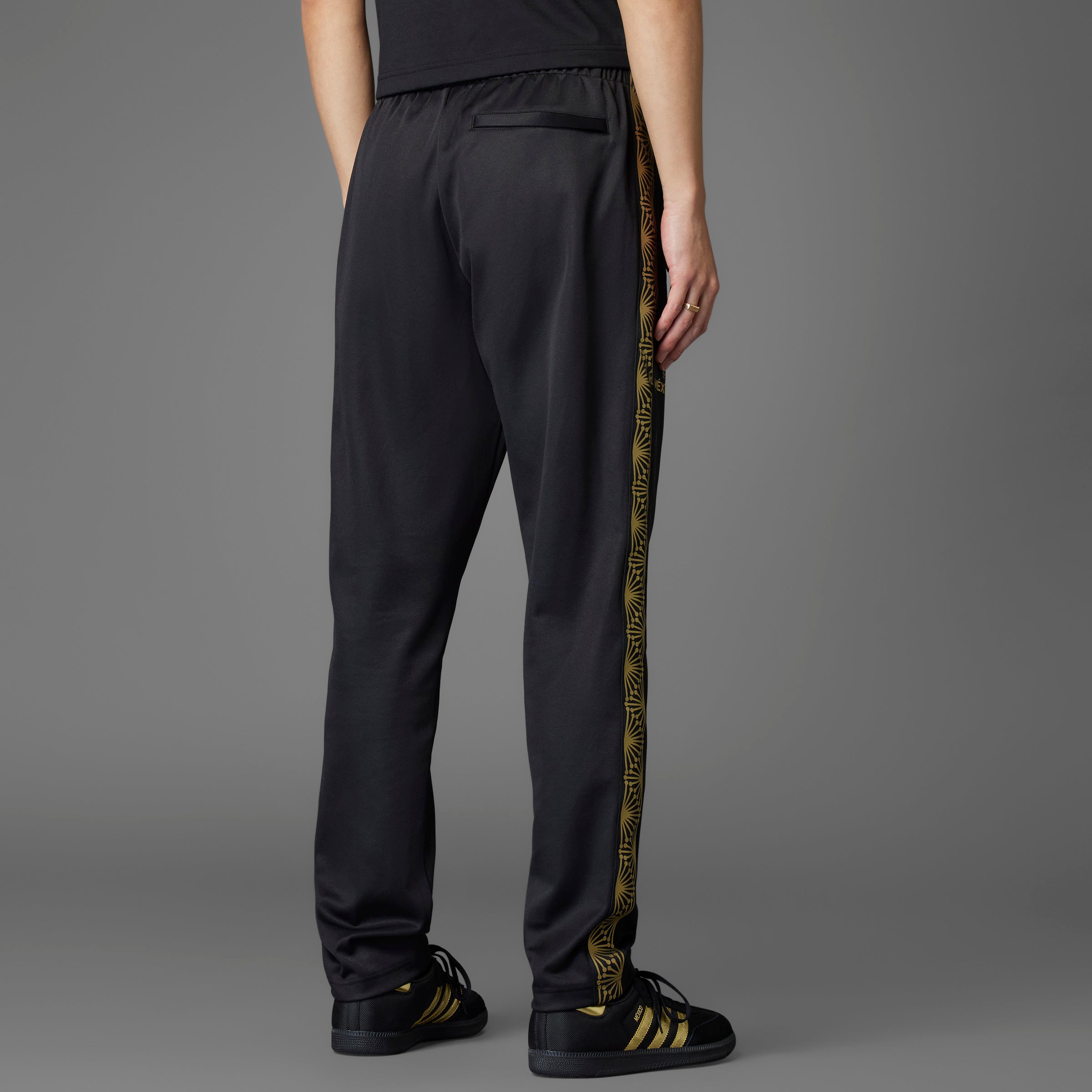 Close-up of the Adidas Mexico soccer track pants showcasing the Trefoil logo and elastic waist with drawcord.